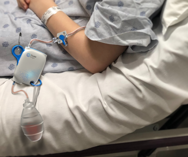 Hospital patient in a bed with FluidAI's sensor device attached to them.